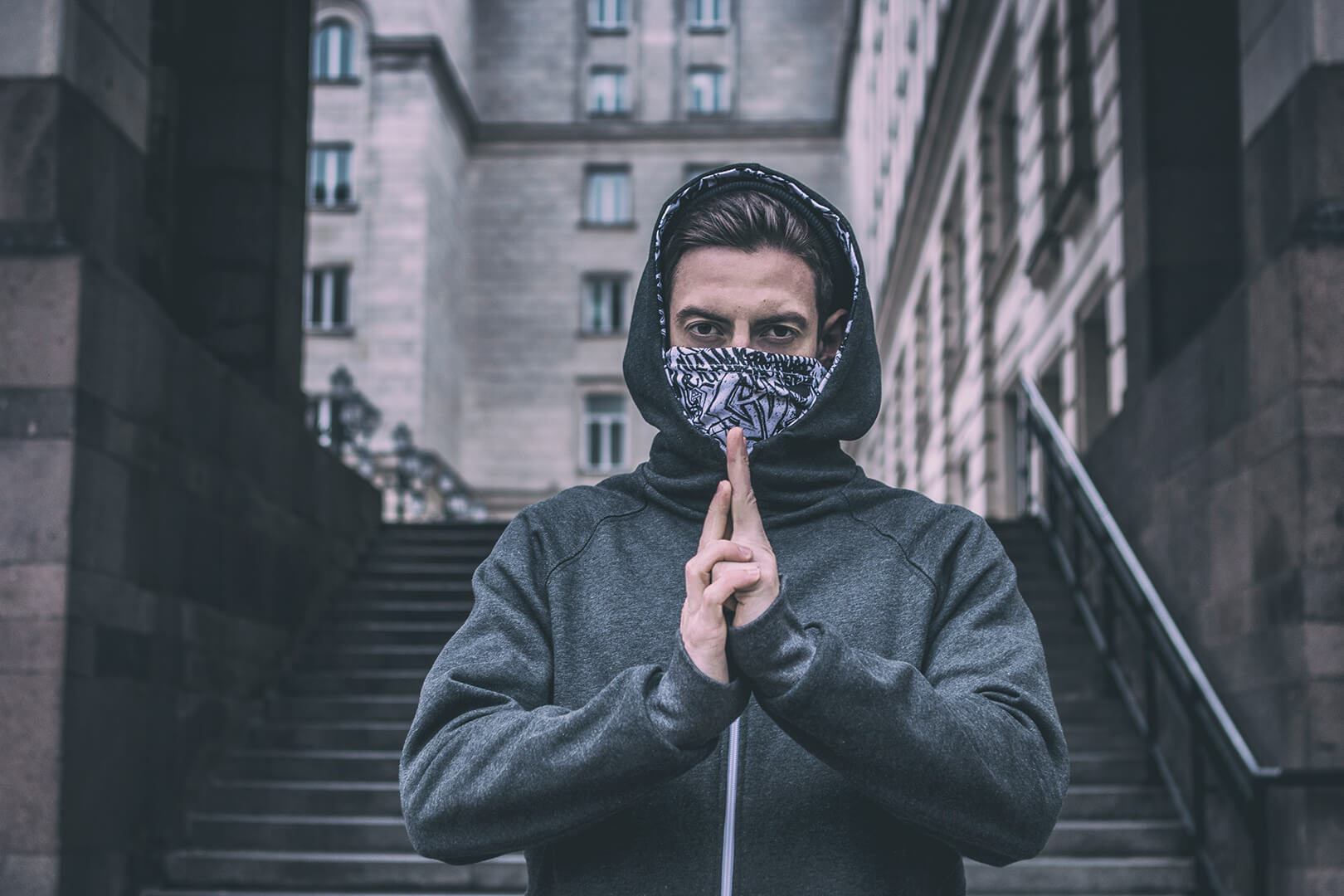 GOLOKA Men category: model in a gray hoodie on stone steps
